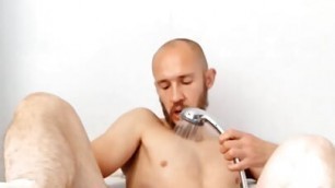 Bearded guy jerks his dick and asshole with the shower