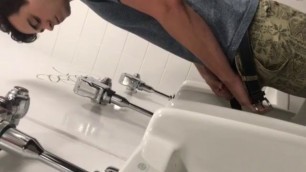 A male is pissing in the toilet 16.